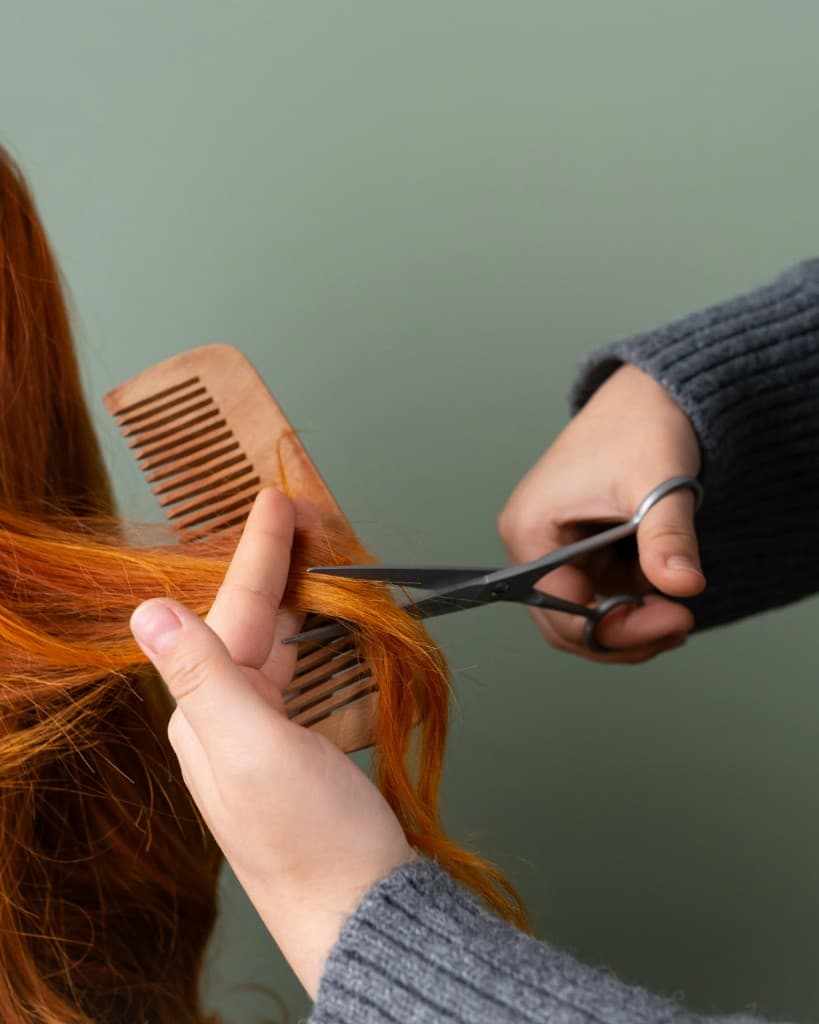 Stylist cutting hair behind the chair